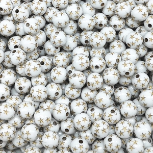 Macro view of white round acrylic beads with golden star patterns for DIY jewelry making