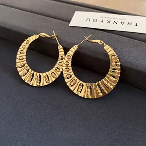 Vintage gold twisted hoop earrings with beaded detailing in C-shape bohemian design
