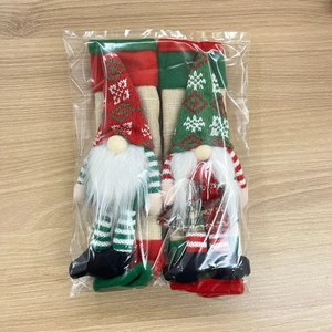 Detailed view of two Christmas gnome refrigerator handle covers in transparent packaging
