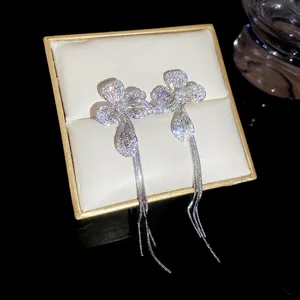 Elegant silver flower earrings with zircon pavé and long snake chain tassels in jewelry box