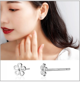 Macro detail of S999 sterling silver flower studs and earring worn by a model