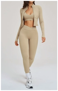 Detailed view of sand-colored 3-piece fitness set with zip jacket and crossover leggings