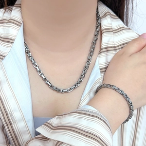 Polished silver punk hip-hop chain necklace and bracelet set shown on model
