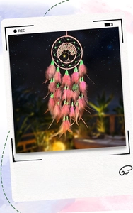 Detail of pink feathers and life tree pendant with luminous beads and natural crystals