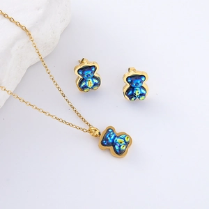 Colorful resin bear necklace and earrings set with iridescent blue finish on gold chain