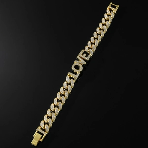Close-up of gold-plated iced-out Cuban link bracelet with rhinestone LOVE letters