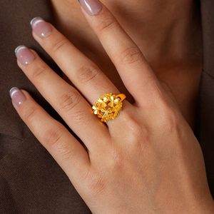 Macro shot of 24k gold-plated floral ring featuring a layered clover-shaped petal design