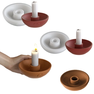 Detail view of heart-patterned resin mold with finished clay candle holder and candle