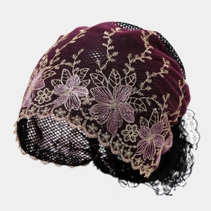Close-up of elegant purple lace beanie featuring golden floral embroidery and black mesh detail