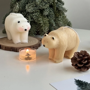 Polar bear scented candles with pine cones and wood slices for home decor