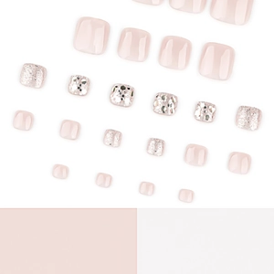 Cat-eye glitter press-on toenails in nude pink with silver sequins on white background