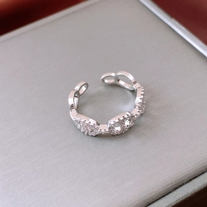 Detailed view of silver pig nose ring featuring micro-set cubic zirconia on anchor links