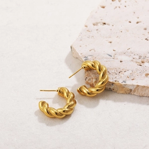 Detailed shot of 18K gold plated hoop earrings with spiral twisted rope texture on stone