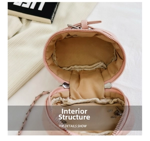 Detailed view of the pink quilted bag internal structure with beige lining and metal clasp