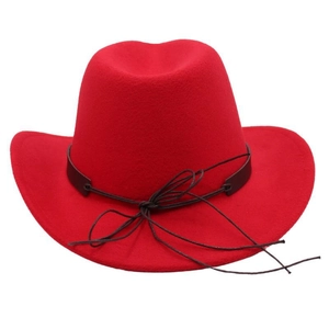 Detail of red wool felt cowboy hat featuring a black leather band and wide brim