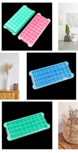 Detail of silicone ice cube trays with lids in green pink and blue for home use