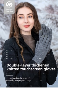 Detailed view of gray thermal knit gloves with touchscreen tips in a snowy outdoor scene