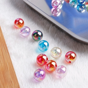 Colorful iridescent acrylic round beads for DIY handmade jewelry on white plush background