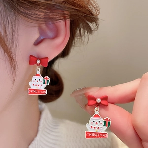 Detail of Christmas snowman earrings with red bow, pearl accent and festive striped scarf
