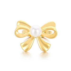 Minimalist gold bow-shaped ring with a central white pearl on a clean white background