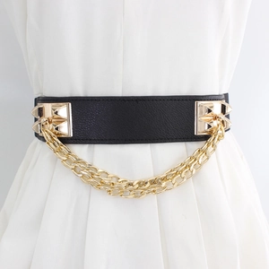 Women's wide black elastic waist belt with gold punk chains and studs on white dress