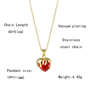 Detail view of heart pendant with red faceted stone and gold melting design, size 19x11mm