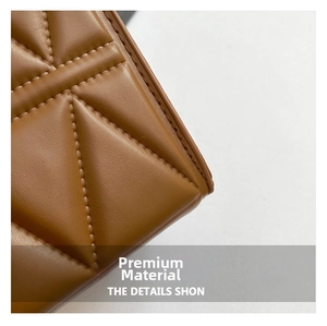 Close-up of caramel brown quilted leather texture with premium diamond stitching pattern