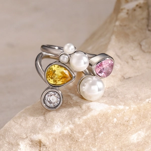 Detail of 18k gold plated ring with white pearls, pink and yellow pear-cut gemstones