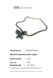 Detail of green crystal butterfly pendant with dimensions 1.7x1.7cm and silver chain