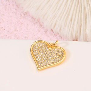 Macro shot of 14K gold-plated heart pendant with faceted colorful zircon stones
