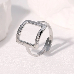 Macro shot of silver square open ring with handcrafted hammered texture on stone