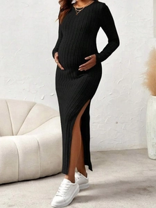 Detail shot of black ribbed knit maternity dress with a high side slit on a model