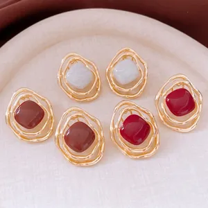 Set of 3 irregular wavy gold earrings with white, red, and brown resin inlays