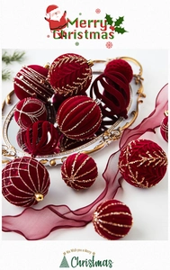 Detail of burgundy flocked Christmas balls with gold glitter patterns on a mirror tray