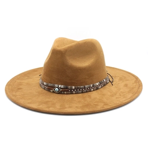 Brown wide brim suede fedora hat with metal rivets and blue evil eye charm detail