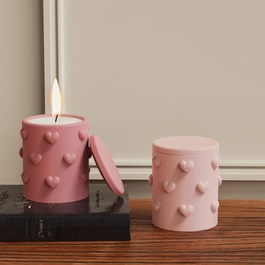 Detailed view of pink heart-embossed silicone molds for gypsum candle storage jars