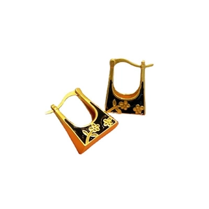 Retro golden hoop earrings with black enamel and delicate floral patterns on white background