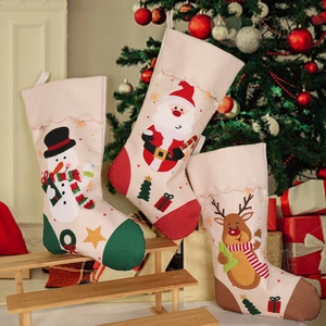 Three Christmas stockings with Santa, Snowman, and Reindeer set on wooden stand