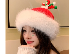 Detailed close-up of a festive red Christmas knit hat with white fur trim and antlers