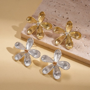 Metallic flower stud earrings with brushed texture in gold and silver finish