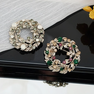 Detailed macro shot of vintage baroque floral brooches with crystals on a black surface