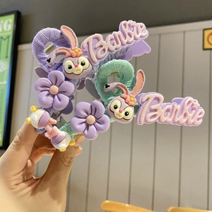 Detail of candy color hair clips featuring Barbie text and StellaLou character design
