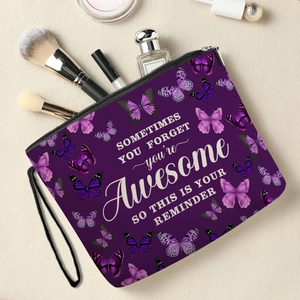 Purple butterfly makeup bag with inspirational quote surrounded by cosmetics