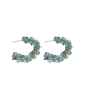 Aquamarine beaded C-shaped hoop earrings with gold beads on a clean white background
