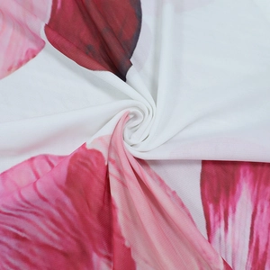 Close-up of lightweight sheer mesh fabric with pink and red floral petal print