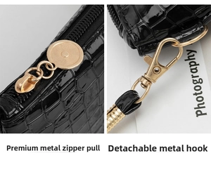Close-up view of the glossy bamboo grain texture with gold hardware zipper pull and clasp