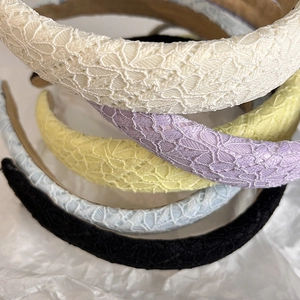 Detailed close-up of lace headbands in five pastel colors with 3D floral embroidery textures