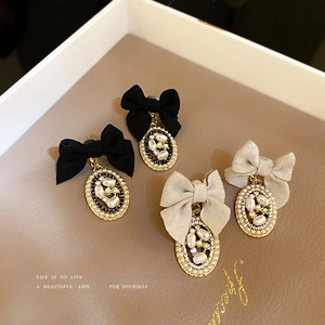 French vintage bow earrings with baroque pearls and rhinestones in a jewelry box