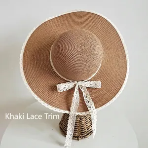 Cappello da sole in paglia kaki da donna con pizzo bianco e fiocco su supporto