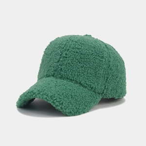 Close-up of the plush green sherpa texture and stitching on the warm baseball cap